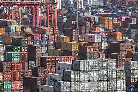 Image of many shipping containers stacked upon one another
