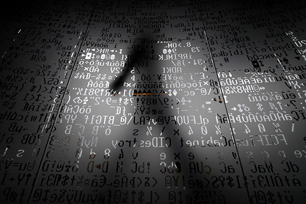 image of shadowy figure over computer code
