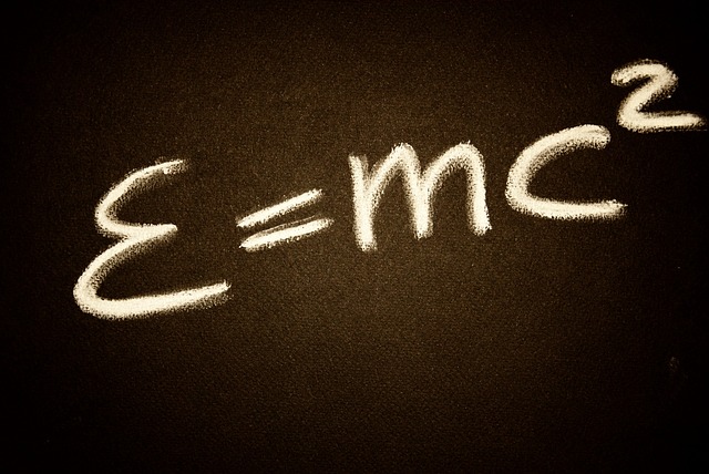 Einstien's E=mc2 equation written on a chalk board