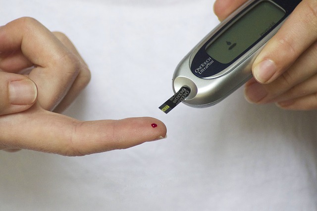 Hands using a blood glucose test meter