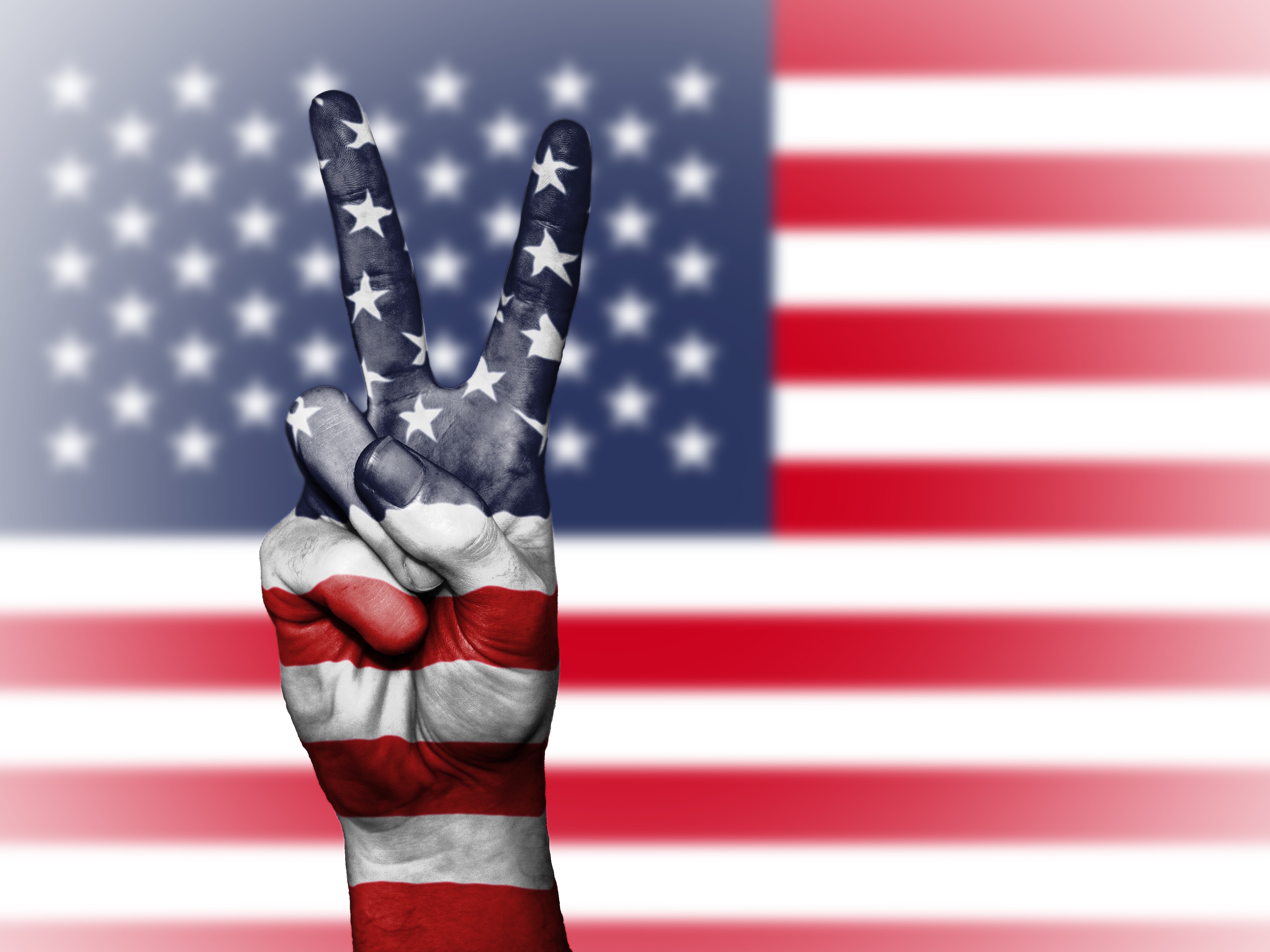 USA flag and hands making a peace sign