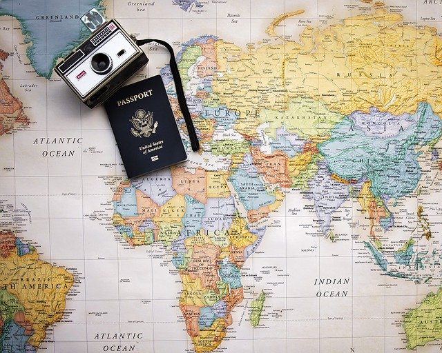 Image of a map, a camera, and a passport