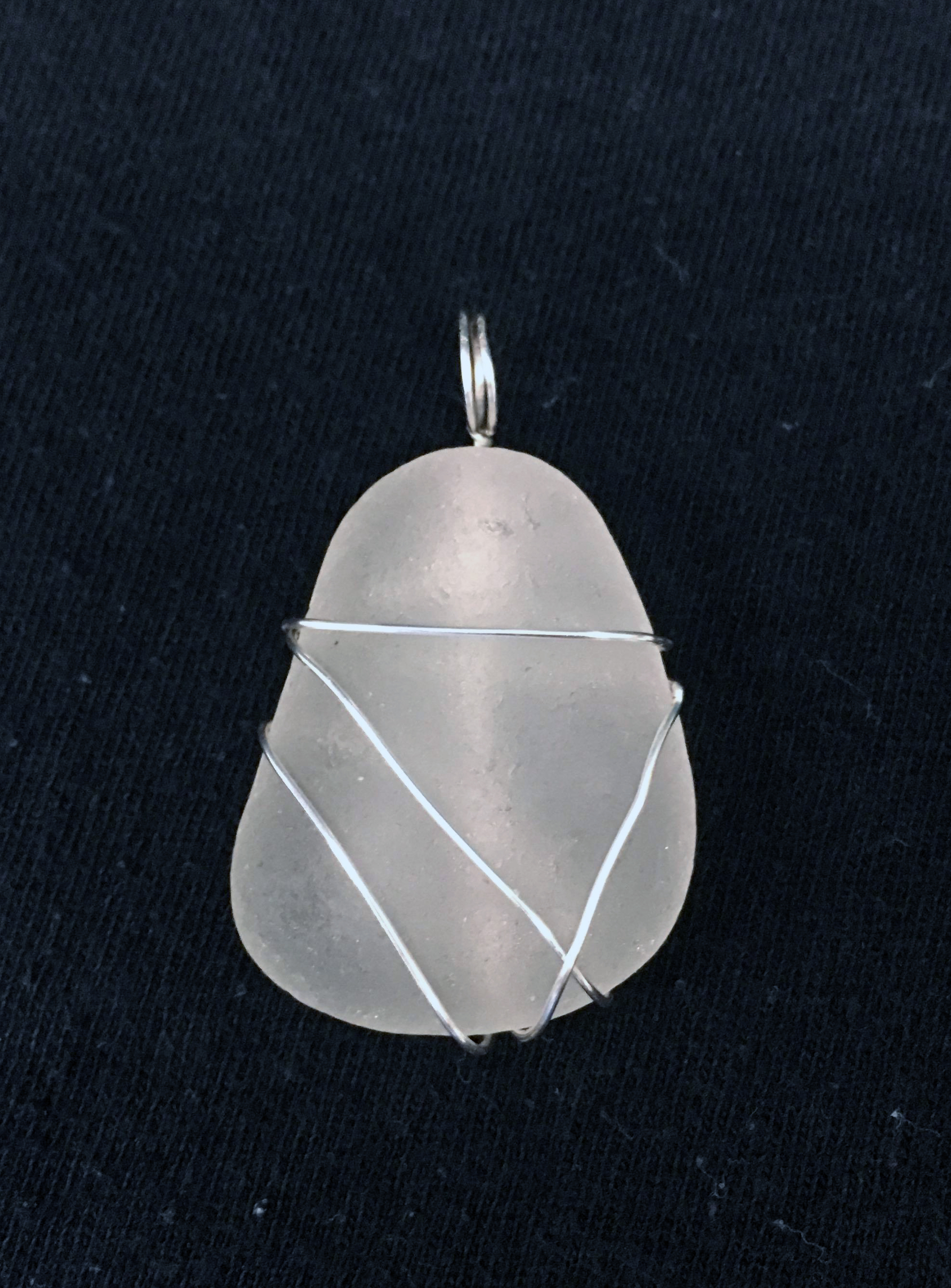 Pretty stone wrapped in wire and made into a pendant.