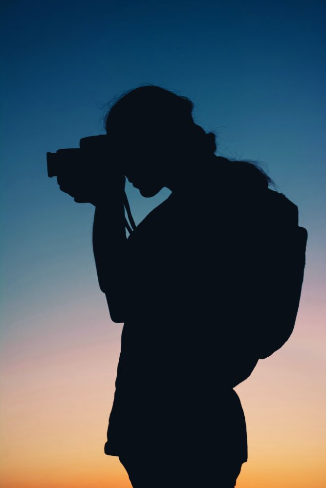 Silhouette of person taking a photo 