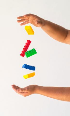 Little hands holding Legos