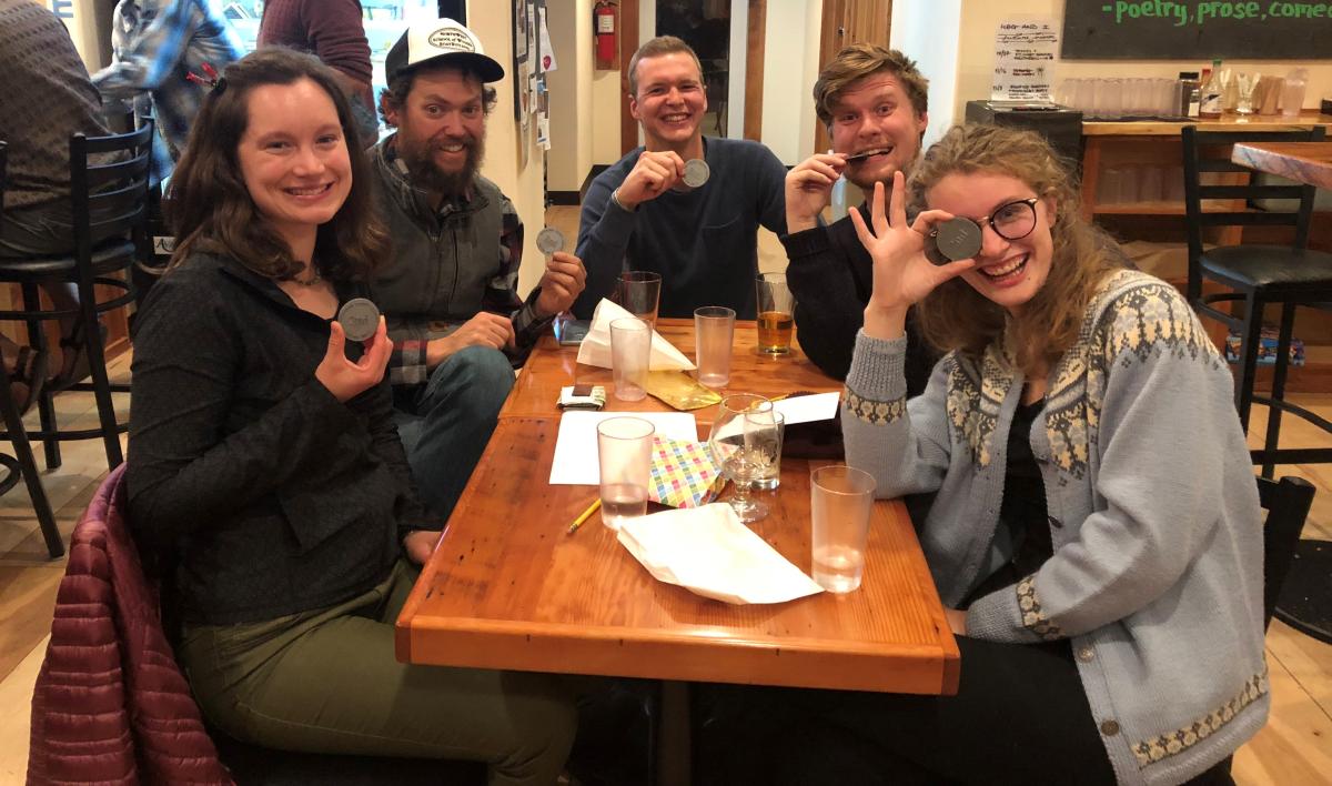 Group of adults sitting at a table during a trivia event