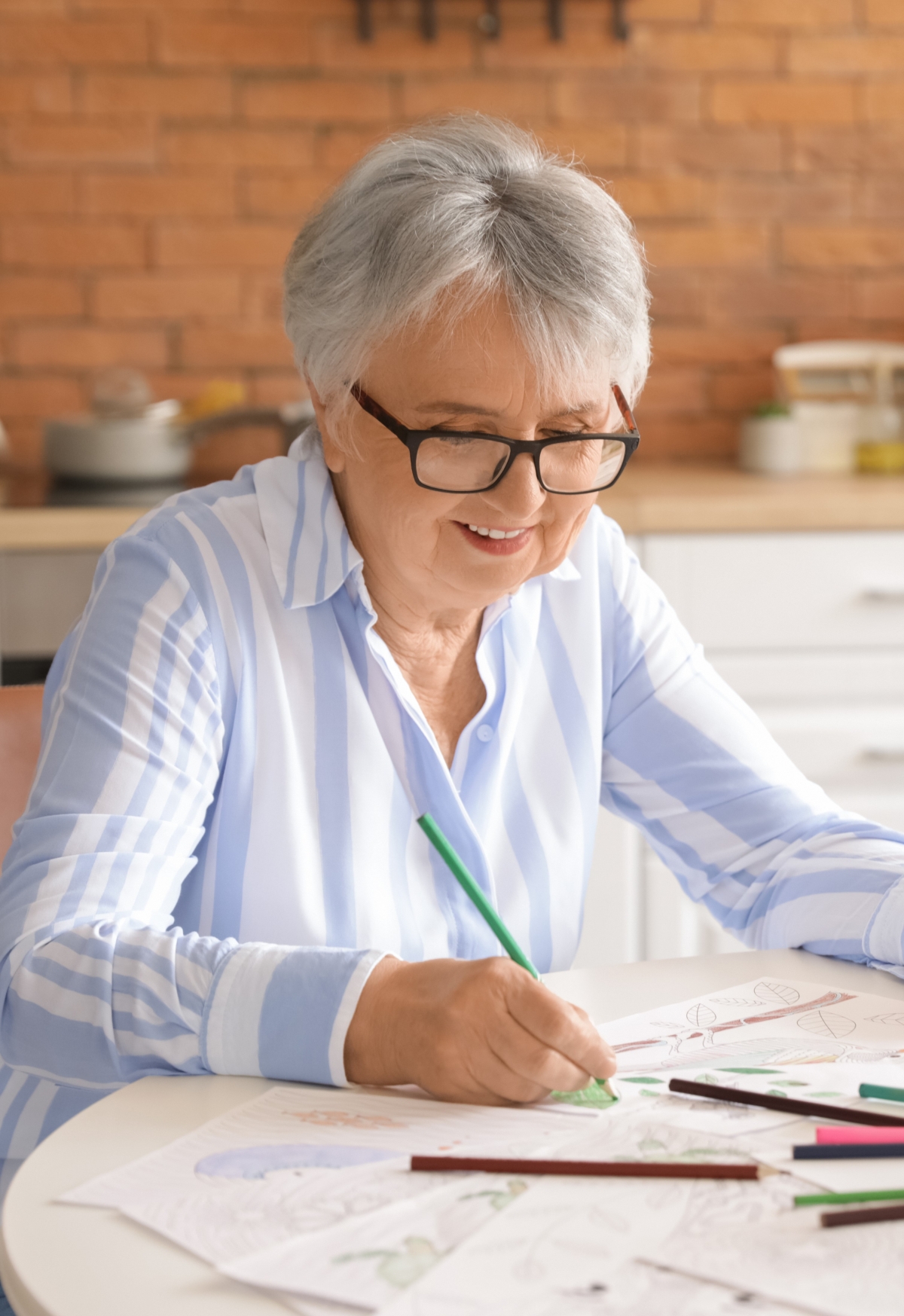 Older woman drawing with pencils