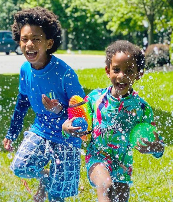 Two boys playing in the water.